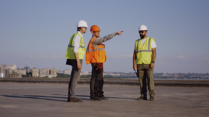 Anonymous builders with laptop on construction site