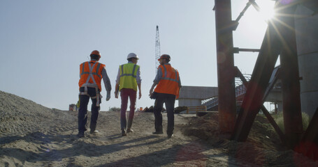 Inspectors walking on bridge construction site