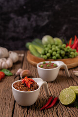 Red Eye Chili Paste with Lemon and Chili on Wooden Floor