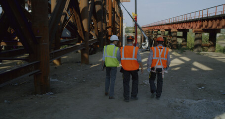 Inspectors walking on bridge construction site