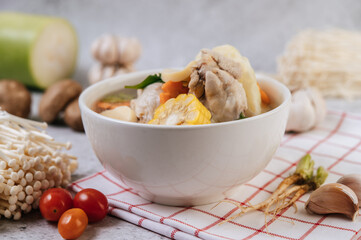 Chicken soup with corn, shiitake mushroom, enoki mushroom, and carrot.