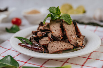 Grilled Liver Slices with sliced ​​lime, carrots, chili, spring onions, and mint.