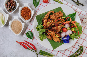 Pork Nam Tok with fried chili, tomato, lime, cucumber, and fresh pepper.