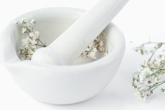 Mortar and pestle with flowers