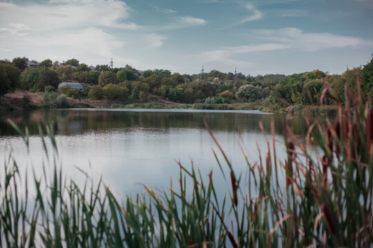 Dramatic landscape of village near lake and forest.