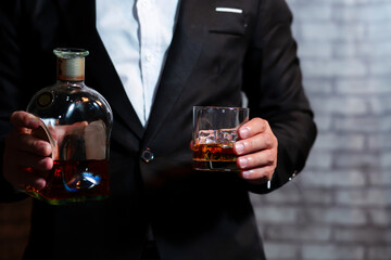 Closeup businessmen holding a glass of whiskey