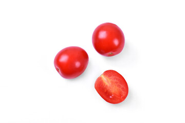 Two red fresh cherry tomatoes and one sliced on white background