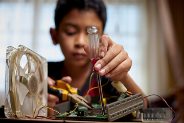 Asian Schoolboy studying electronic at home 