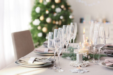 Beautiful table setting with Christmas decorations in living room
