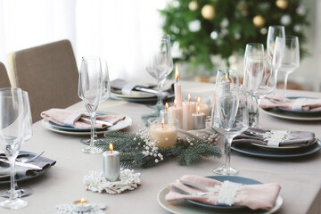 Beautiful table setting with Christmas decorations in living room