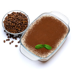 Traditional Italian Tiramisu dessert in glass baking dish and coffee beans isolated on white