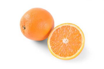 Two oranges one sliced on half on white background