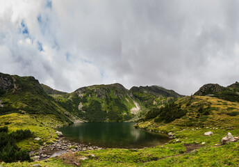 beautiful mountain lake in a green landscape panorama