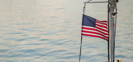 American flag on a mast of ship.
