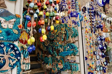 Bodrum, Turkey - August, 2020: souvenirs with evil eyes, masks, lanterns at the local market. Turkish souvenirs of Grand Bazaar. With selective focus