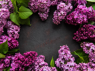 Beautiful spring flowers lilac on dark stone background with place for text. Syringa vulgaris. Happy Mother's Day greetings card. Top view. Copy space.