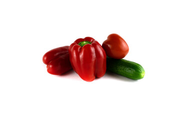 Two red sweet peppers cucumber and tomato
