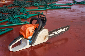 Chain saw laying on deck of ship