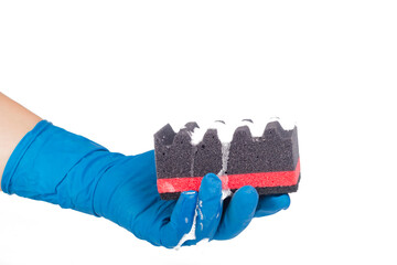 A man's hand in a blue household glove holds a corrugated black sponge, dishwashing detergent is applied. On white background. Close-up