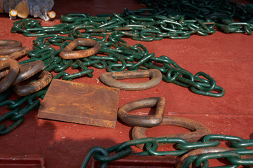Cargo lashing chains, stoppers and d-rings on deck of merchant cargo ship
