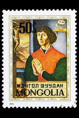 A postage stamp printed in Mongolia shows a portrait of Nicolaus Copernicus with folded palms, circa 1973. Macro photography. Complete clipping. Vertical layout.