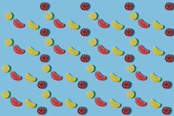 Food pattern. Repetition of the silhouette of bright candies of different shapes on a blue...
