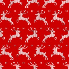 Seamless pattern with knit deers and snowflakes on red background. Christmas print for clothing, kitchen textiles and wrapping paper.