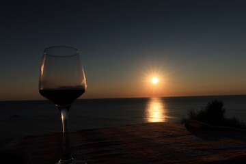 glass of red wine at sunset