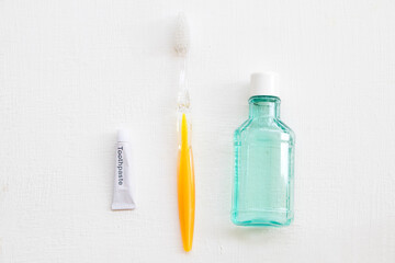 toothbrush ,toothpaste and mouthwash health care for oral cavity arrangement flat lay style on background white wooden