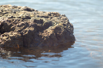 Rocky rock in the blue ocean water
