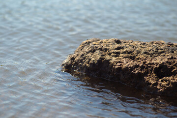 Rocky rock in the blue ocean water