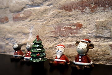 Santa claus, animals and pine trees christmas day on black table brown brick background