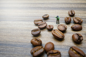 miniature photographer take a picture of coffee beans 