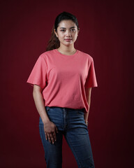 Front view pink t-shirt Closeup on female body, woman girl in empty yellow t-shirt isolated on red background. Design woman t-shirt template and mockup for print.
