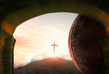 Easter concept: Tomb empty with cross on sunset background