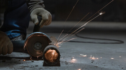 worker cutting metal with sparks
