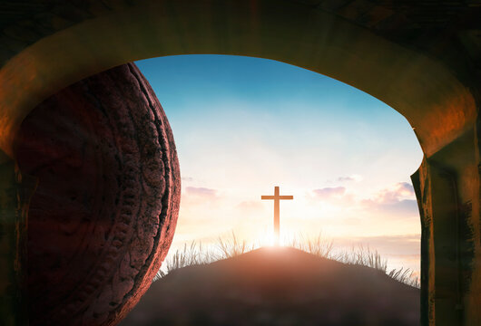 Easter  concept: Tomb empty with cross on sunset background