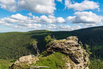 Fototapeta na wymiar Sokoli skala rock formation with hills on the background in Jeseniky mountains in Czech republic