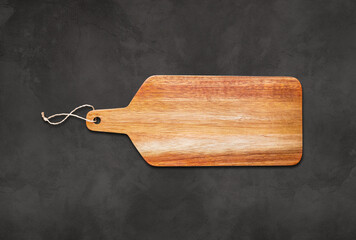 Wooden cutting board isolated on concrete background