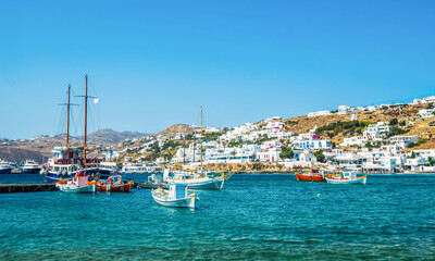 Fototapeta na wymiar Ships on blue water with Mykonos island at background