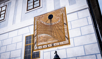 Anchient painted sun clock on the wall in Cesky Krumlov