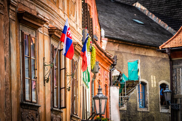 Fototapeta na wymiar Side view of old building's architecture with nathional czech flags in Cesky Krumlov