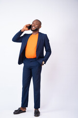 happy african businessman making a phone call