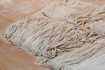 A man preparing traditional Japanese fresh soba buckwheat noodles from scratch in Kyoto, Japan