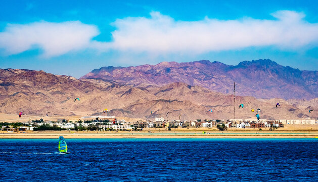 Beatiful seascape and lanscape with glorious mountains and parachutes activities