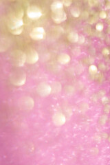 blurred bokeh background of pink and gold glitter