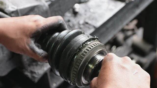 Car Mechanic or Auto Mechanic Assemble Drive Shaft Rubber Boot in Zoom View
