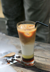 a cup of iced milk coffee on a wooden cafe table. brew fresh coffee for coffee breaks during the day