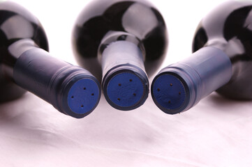 Redwinebottle with a blue cap