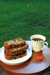 Slices of Banana Bread on white plate and a cup of coffee